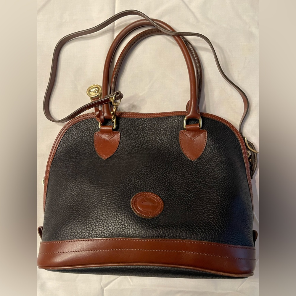 Dooney & Bourne bag with handles and shoulder strap. Black with brown trim